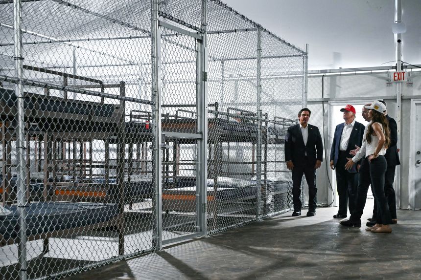 President President Donald Trump, Florida Gov. Ron DeSantis and Secretary of Homeland Security Kristi Noem tour the migrant detention center dubbed